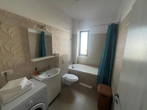 a white bathroom with a sink and a toilet at VISAJ Metropolitan - authorized by the Ministry of Tourism in Giroc +27 photos