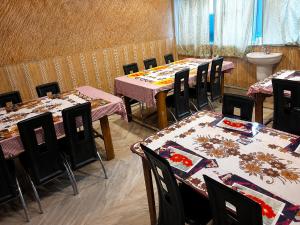 a dining room with tables and chairs in a room at Dooars View Hotel in Hāsimāra