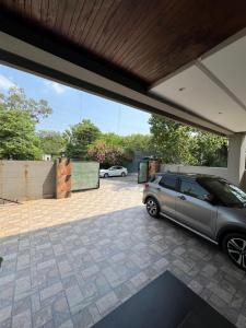 a garage with a car parked in a driveway at brick hotel & luxury suites in Lahore
