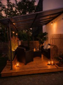 a wooden deck with furniture and lights on it at Wunderschöne Altbauwohnung in Toplage in Biederitz
