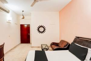 a bedroom with a bed and a red door at Hotel O Le Regent in Gurgaon