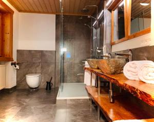 a bathroom with a shower and a counter with towels at Chalet Zugspitze in Grainau +27 photos