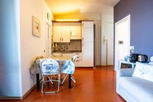a kitchen with a table and two chairs in a room at Moneglia - Le Case di Bart in Moneglia