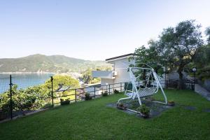 a white chair sitting on top of a yard at Moneglia - Le Case di Bart in Moneglia