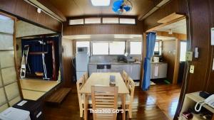 a dining room and kitchen with a table and chairs at 陽だまりハウス in Hiroshima