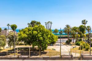 a tree in a park with a fence at Waterfront Riviera in Naples