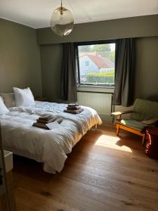 a bedroom with a large bed and a window at Albi's Sandvig Boutique Hotel in Sandvig
