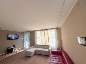 a living room with a couch and a tv at 88 Destination in Treviglio