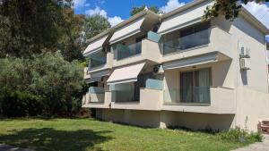 a white building with a yard in front of it at The Archontariki in Ormos Panagias