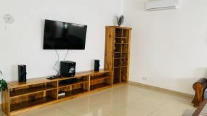 a living room with a flat screen tv on a wall at Villa Tsara Nosy be in Nosy Be