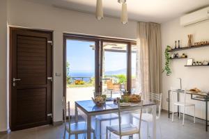 a dining room with a glass table and chairs at Villa Serra d'Elci in Ascea
