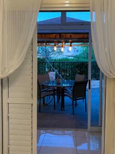 a dining table and chairs on a patio at Seana Hidden Gem in Kapparis in Paralimni