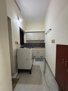 an empty kitchen with a sink and a refrigerator at Stay at Renovated Home at DBRA-61 Don Bosco Cross Road Vaduthala Ernakulam in Cochin +31 photos