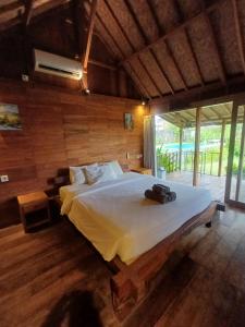 a bedroom with a large bed in a room at Green Bowl Beach Villas in Uluwatu +34 photos