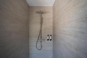 a shower in a bathroom with two bottles at Casamore in Meria +33 photos
