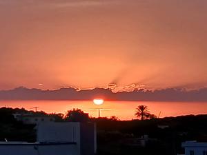 a sunset from the roof of a building at Sidi Kankouch Bay in Tangier +1 photo