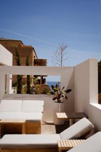 a living room with white furniture and a view of the ocean at Casamore in Meria