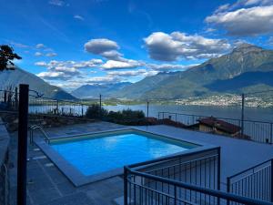 a swimming pool with a view of a lake and mountains at My Holidays Casa Adele in Vercana