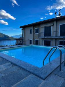 a swimming pool in front of a house at My Holidays Casa Adele in Vercana