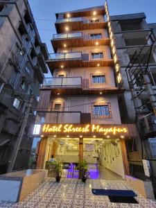 a building with a hotel snodgrass network sign in front at Hotel Shreesh Mayapur in mayapur