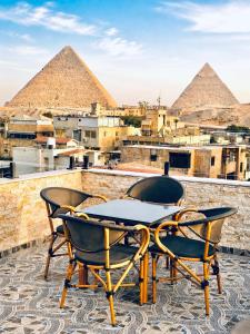 a table and chairs on top of the pyramids at Aziz Egypt Hotel in Cairo