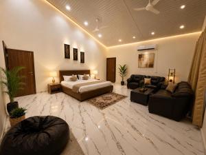 a large living room with a bed and a couch at Vibhor peace cottage in Chitrakoot +9 photos
