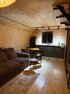 a living room with a couch and a table at Tera Cottages kazbegi in Kazbegi