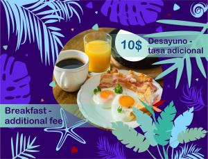 a plate of breakfast food with eggs and a glass of orange juice at SWEET DREAMS Studios and Suite at SOL CARIBE in Punta Cana