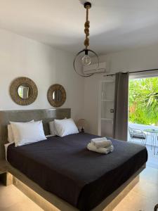 a bedroom with a large bed with a large window at Zoumis Residence in Naousa +196 photos