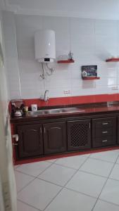 a kitchen with a sink and a counter top at Palm Serenity in Tangier +4 photos