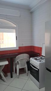 a kitchen with a stove and a bench in it at Palm Serenity in Tangier