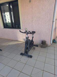 a exercise bike parked next to a building at Comfort Saranda Apartment in Sarandë