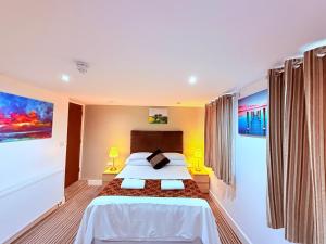 a bedroom with a large bed in a room at RBS Hotel, Rochester in Rochester