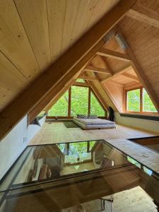 an attic room with a glass floor in a house at Studio MEZILES in Buš