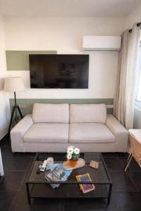 a living room with a couch and a table at The Athenian Pearl in Athens