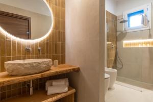 a bathroom with a sink and a mirror at Orsola Apartments in Favignana