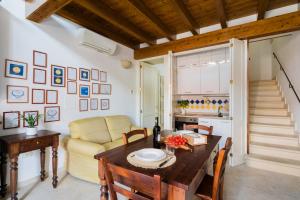 a living room with a table and a couch at Tre Volte Belle - Salento Selection in Carpignano Salentino