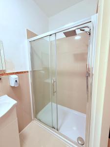 a shower with a glass door in a bathroom at RBS Hotel, Rochester in Rochester