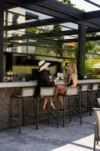 two people sitting at a table in a restaurant at THERMA NUMERA Mineral SPA & Longevity in Burgas