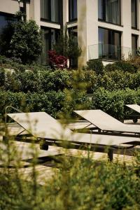 a group of picnic tables in front of a building at THERMA NUMERA Mineral SPA & Longevity in Burgas