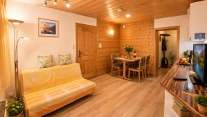 a living room with a couch and a table at Ferienwohnung in Itter bei Söll SkiWelt Wilder Kaiser Kitzbüheler Alpen ITD100 in Itter