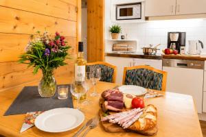 a table with plates of food and a vase of flowers at Ferienwohnung in Itter bei Söll SkiWelt Wilder Kaiser Kitzbüheler Alpen ITD100 in Itter