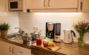 a kitchen counter with a sink and a counter top with aounter at Ferienwohnung in Itter bei Söll SkiWelt Wilder Kaiser Kitzbüheler Alpen ITD100 in Itter