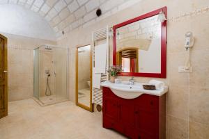 a bathroom with a red sink and a shower at Tre Volte Belle - Salento Selection in Carpignano Salentino