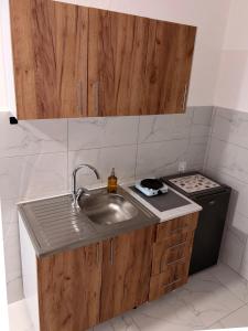 a kitchen with a sink and a stove at Apartman City 2 With 2 Bedrooms and Free Parking in Negotin