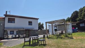 a patio with tables and chairs in front of a building at Islabeach in Isla