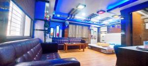 a room with a couch and a bed and a table at Hotel Rodali Residency in Guwahati