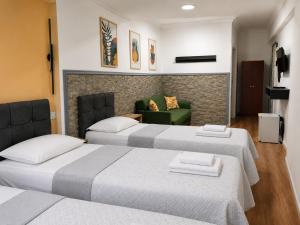 a room with two beds and a couch at Hotel Efesian B&B City Center - Harbour in Kuşadası