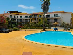 a large swimming pool in front of a building at Santa Maria Ilha do Sal T2 Apartament with pool A&L em Vila Verde in Prainha