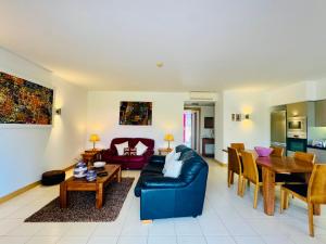 a living room with a blue couch and a table at Santa Maria Ilha do Sal T2 Apartament with pool A&L em Vila Verde in Prainha